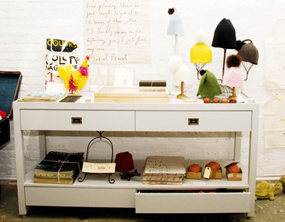 Photograph of a large central table and retail display cases for Partners & Spade's original downtown office & storefront. Design: Partners & Spade, Rogers Marvel Architects